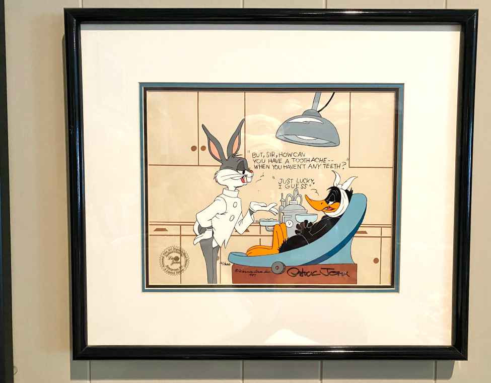Artwork of Bugs Bunny treating Daffy Duck for a toothache.